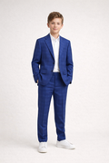 Young boy wearing a blue suit with a white shirt on a white background