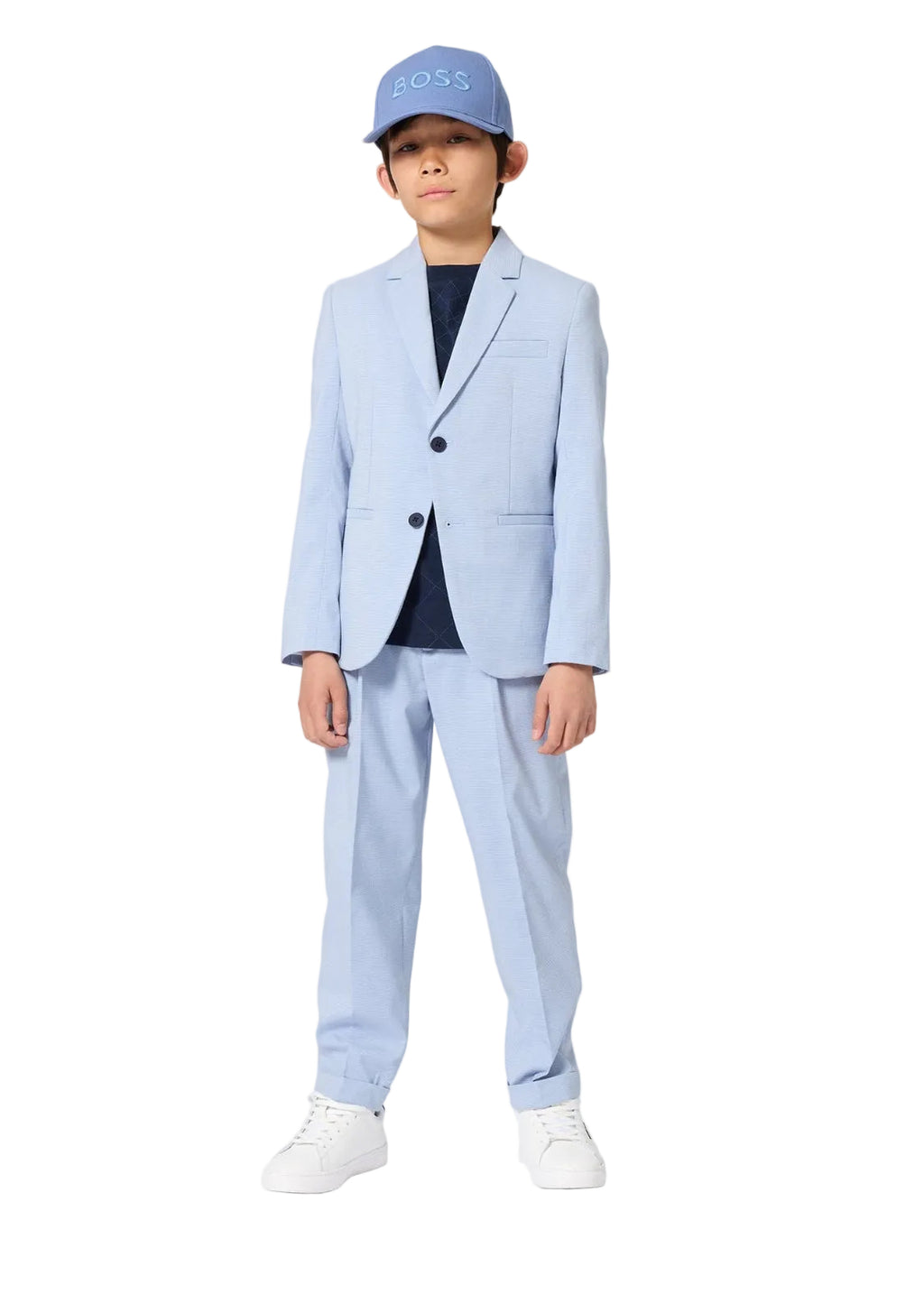 Child wearing a light blue suit and cap on a white background