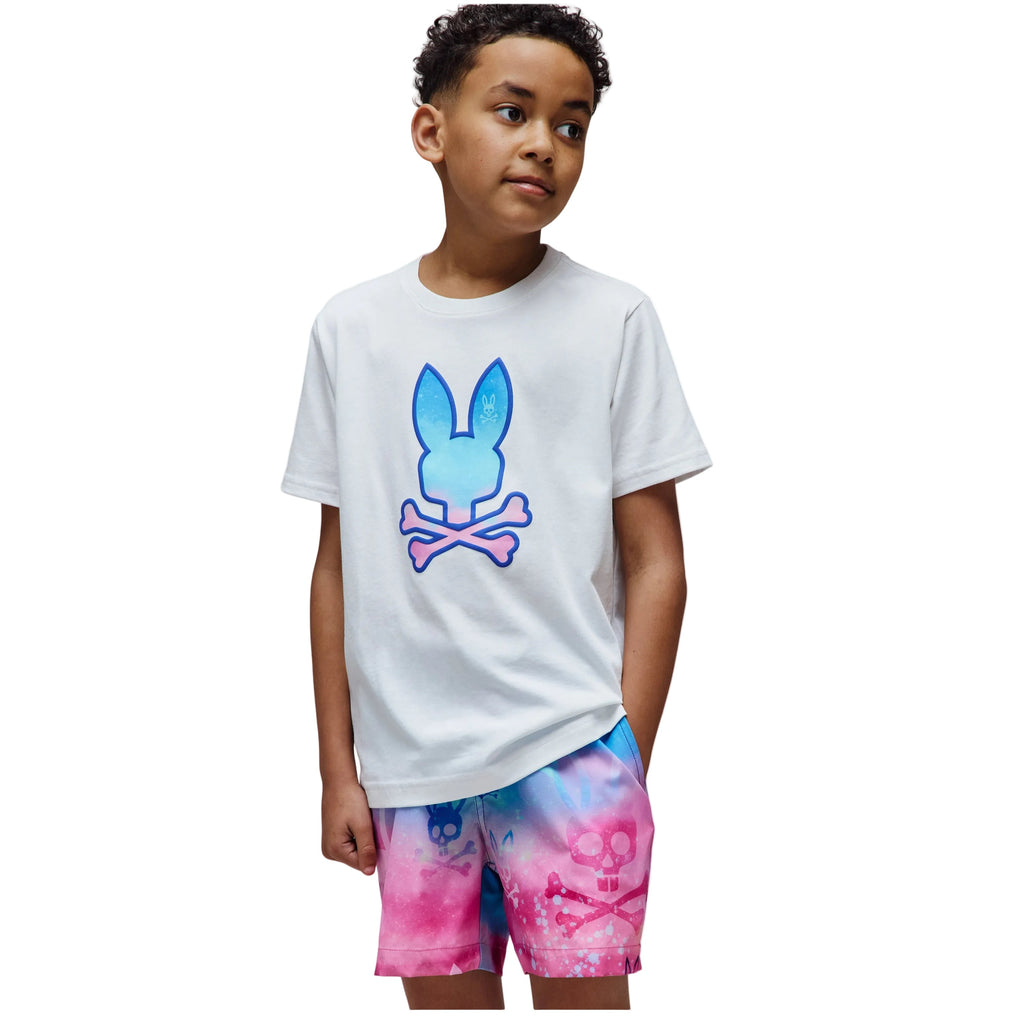 Child wearing a white t-shirt with a colorful graphic and tie-dye shorts on a white background