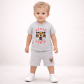 Child wearing a gray Kenzo Paris outfit with a tiger logo on a white background